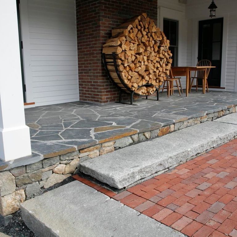Application image for Reclaimed Granite Foundation Stone. The image shows this material being used in a monolithic steps application. This is a building and landscape stone for outdoor commercial and residential applications. Suitable for general use, freeze-thaw conditions, low heat absorption surfaces, high traffic areas and low slipperiness surfaces situations. Higher to high on the price spectrum.