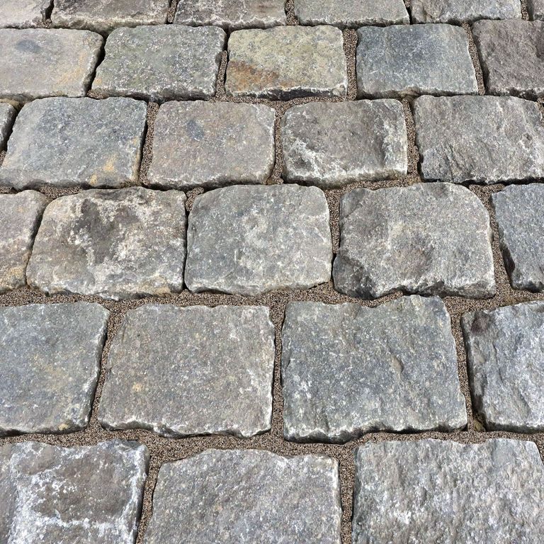Application image for Reclaimed European Porphyry Cobblestones. The surface finish shown is . The dominant color shown is gray; with beige, black, blue, brown, green, purple, white, tan and cream secondaries. The color mix creates a warm feeling. Speckled and blotched color patterns.