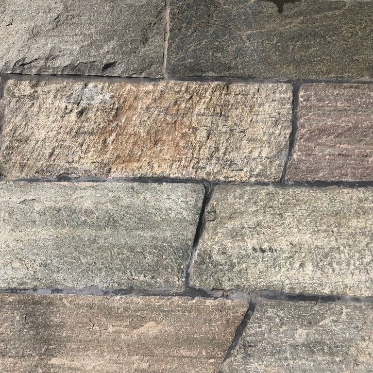 Close-up image for Reclaimed Quartzite Plank Pavers. The surface finishes shown are split-face with flat plane and weathered. Dominant colors shown are beige, brown and gray; with green, orange/rust, purple, white, tan and cream secondaries. Exhibits 