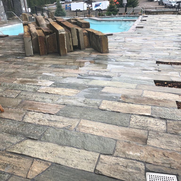 Feature image for Reclaimed Quartzite Plank Pavers. The image shows this material being used for patio pavers and pool deck pavers. Dominant colors shown are beige, brown and gray; with green, orange/rust, pink, purple, white, tan and cream secondaries. The color mix creates a warm feeling. Regular and blotched color patterns.