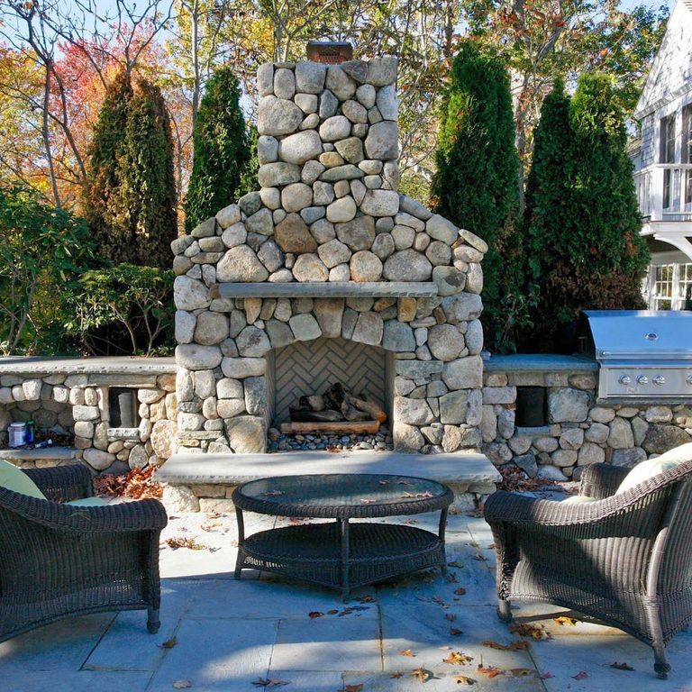 Application image for New England Fieldstone Rounds. The image shows this material being used for outdoor fire concepts and full bed veneer. The surface finish shown is weathered. The dominant color shown is gray. The color mix creates a warm feeling.