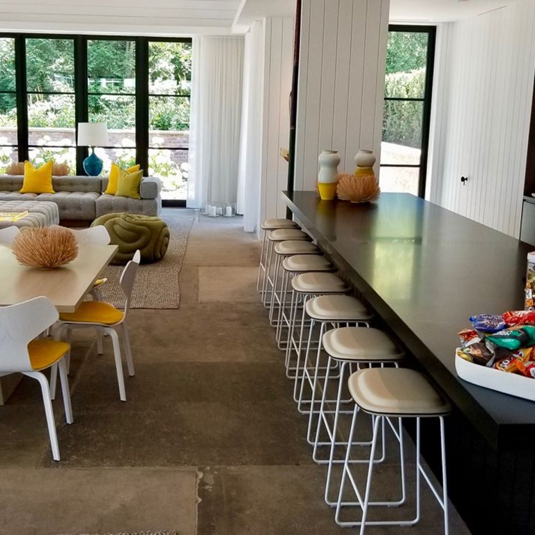 Feature image for Reclaimed Sandstone Sidewalk Stones. The image shows this material being used in an interior floor application. Dominant colors shown are brown and gray; with beige, orange/rust and tan secondaries. The color mix creates a warm feeling. Regular color pattern.