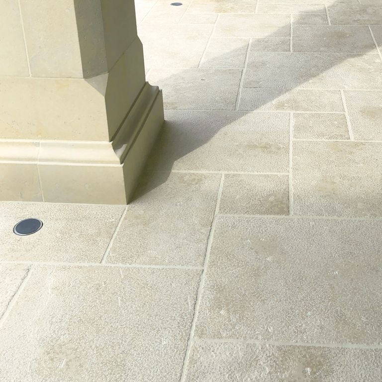 Application image for Mountain Hard Limestone - Beige. The image shows this material being used in a patio pavers application. The surface finish shown is . Dominant colors shown are beige, gray and cream. The color mix creates a warm feeling. Regular color pattern.