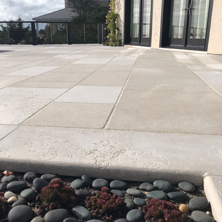 The image shows this material being used in a patio pavers application. Dominant colors shown are beige, white and cream; with yellow and tan secondaries. Solid, regular, speckled and fine speckled color patterns.