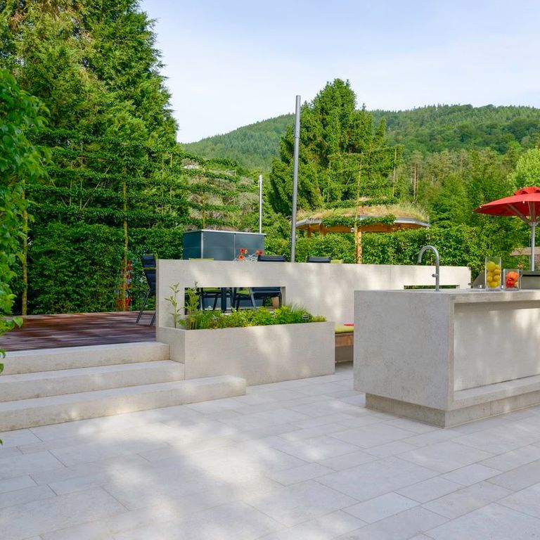 Application image for Limestone - Mountain Hard Beige. The image shows this material being used in a patio pavers application. Dominant colors shown are blue and gray. The color mix creates a cool feeling.
