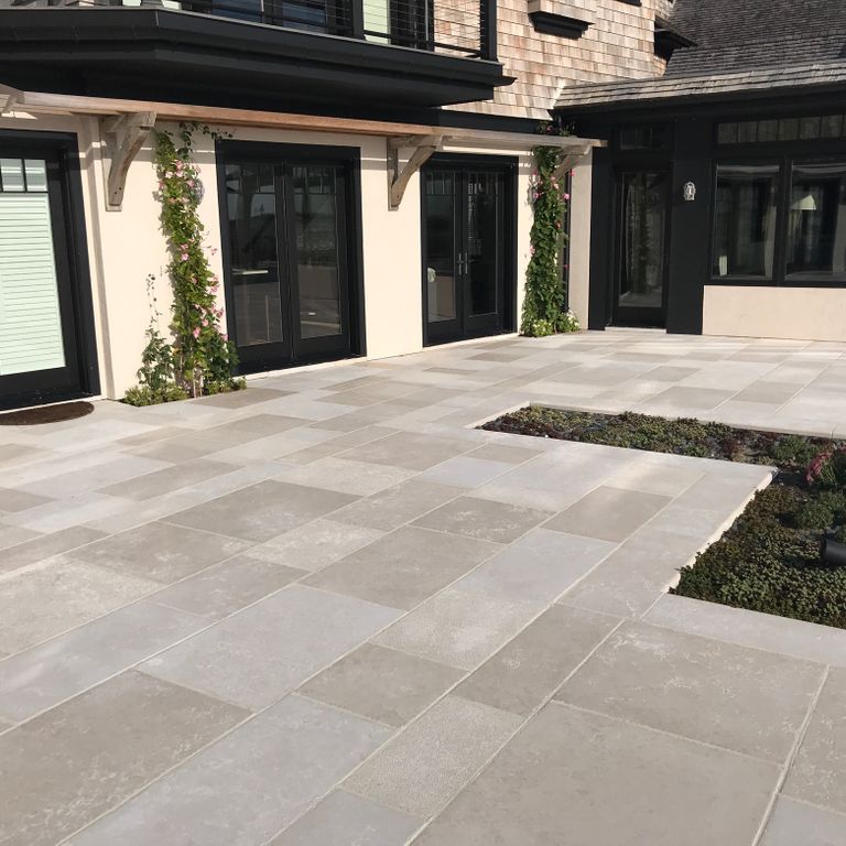 Application image for Limestone - Mountain Hard Beige. The image shows this material being used in a patio pavers application. The dominant color shown is gray. The color mix creates a warm feeling.