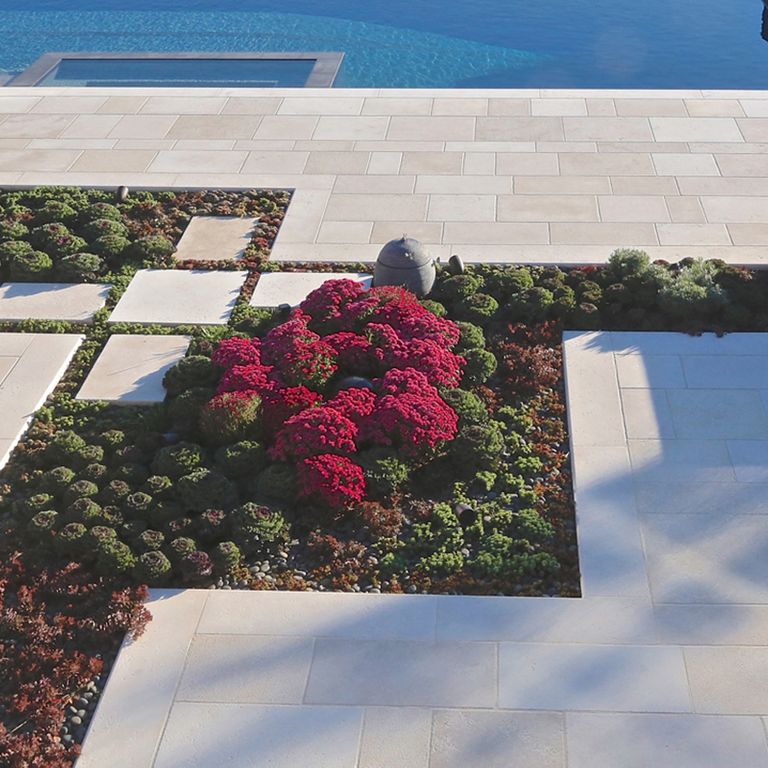 Application image for Limestone - Mountain Hard Beige. The image shows this material being used for pool coping, patio pavers and pool deck pavers. The dominant color shown is beige. The color mix creates a warm feeling.