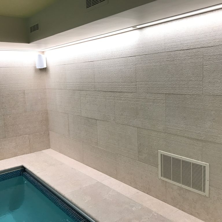 Application image for Mountain Hard Limestone - Beige. The image shows this material being used for pool coping, full bed veneer, thin veneer and pool deck pavers. The surface finish shown is a combination of  and flamed. The dominant color shown is gray. The color mix creates a warm feeling. Regular color pattern.
