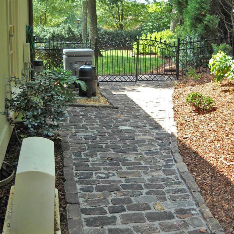 Close-up image for Reclaimed Midwest Sandstone Cobblestones. The surface finishes shown are weathered and worn. The dominant color shown is gray; with beige, black, blue, brown, green, orange/rust, purple, white and tan secondaries. Random, speckled and blotched color patterns.
