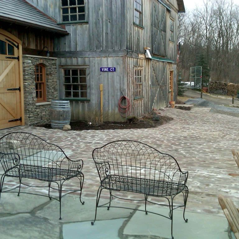 The image shows this material being used for driveway pavers and patio pavers.