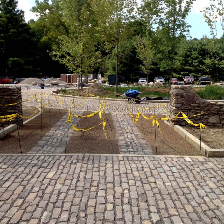 The image shows this material being used in a driveway pavers application.