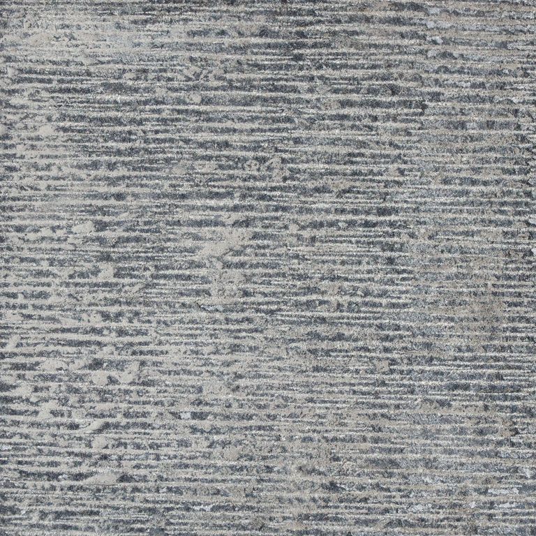 Feature image for Nordic Black Basalt. The surface finish shown is fine adze. The dominant color shown is gray; with beige, black, blue, brown, green, purple and white secondaries. The color mix creates a cool feeling.
