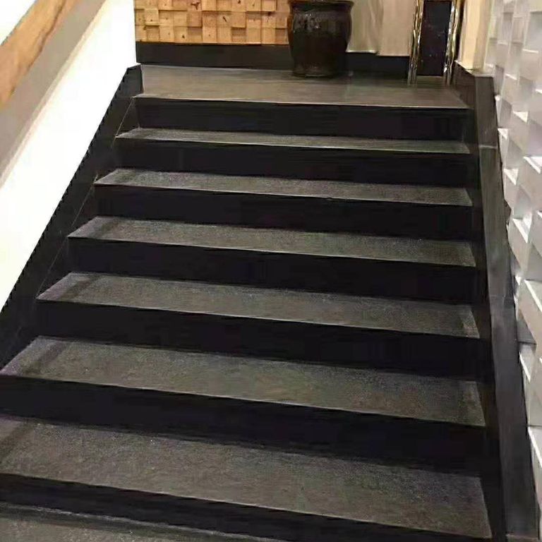 Application image for Nordic Black Basalt. The image shows this material being used in a monolithic steps application. This is a building and landscape stone for indoor and outdoor commercial and residential applications. Suitable for general use, freeze-thaw conditions, low heat absorption surfaces, high traffic areas and low slipperiness surfaces situations. Moderate to higher on the price spectrum.