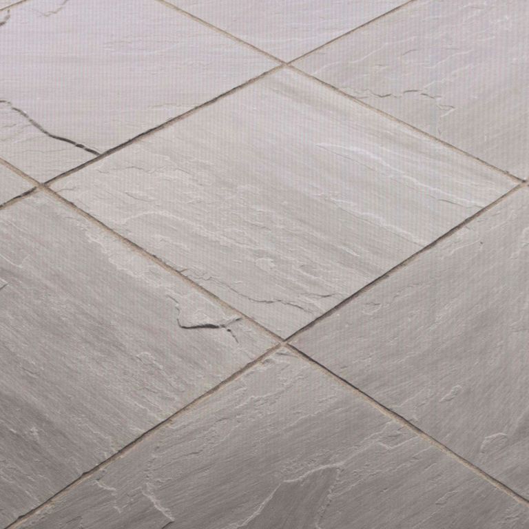 Best close-up image for Sandstone - Asheville. The image shows this material being used in a path pavers application. The dominant color shown is gray; with beige, pink, purple, white and tan secondaries. Exhibits 