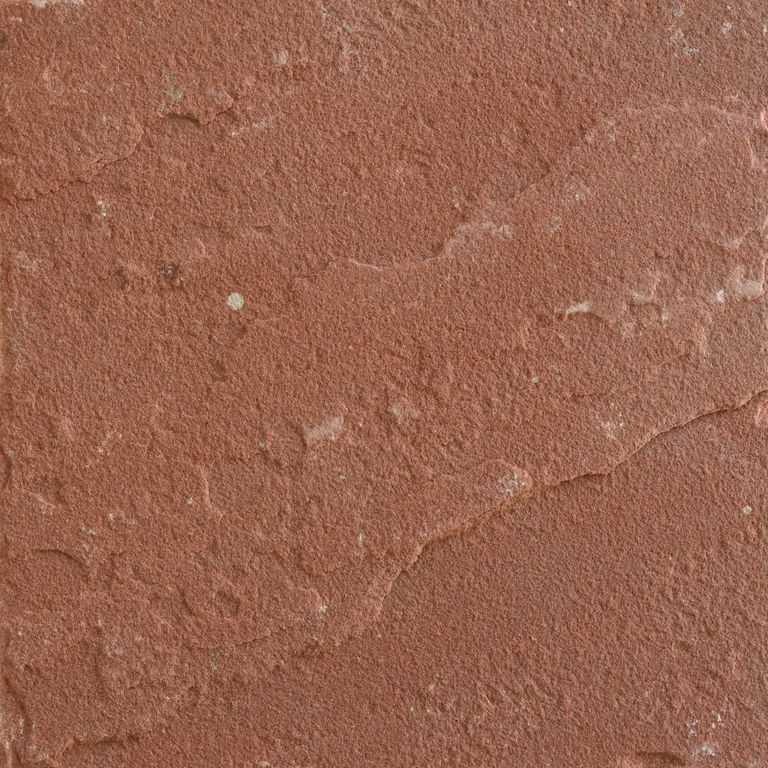 Feature image for Terra Sandstone. The surface finish shown is natural cleft. Dominant colors shown are orange/rust and red; with a tan secondary. The color mix creates a warm feeling. Solid color pattern.