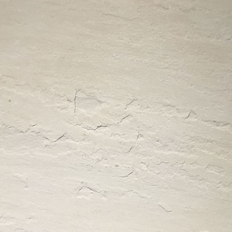 Color/Finish variation image for Portland White Sandstone. The surface finish shown is antiqued. Dominant colors shown are beige and cream; with gray, white and tan secondaries. Exhibits 