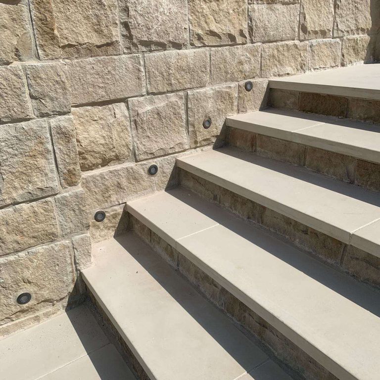 Application image for Portland White Sandstone. The image shows this material being used in a treads application. This is a building and landscape stone for indoor and outdoor residential applications. Suitable for general use, low heat absorption surfaces, high traffic areas and high heel compatibilty situations. Relatively higher in price.
