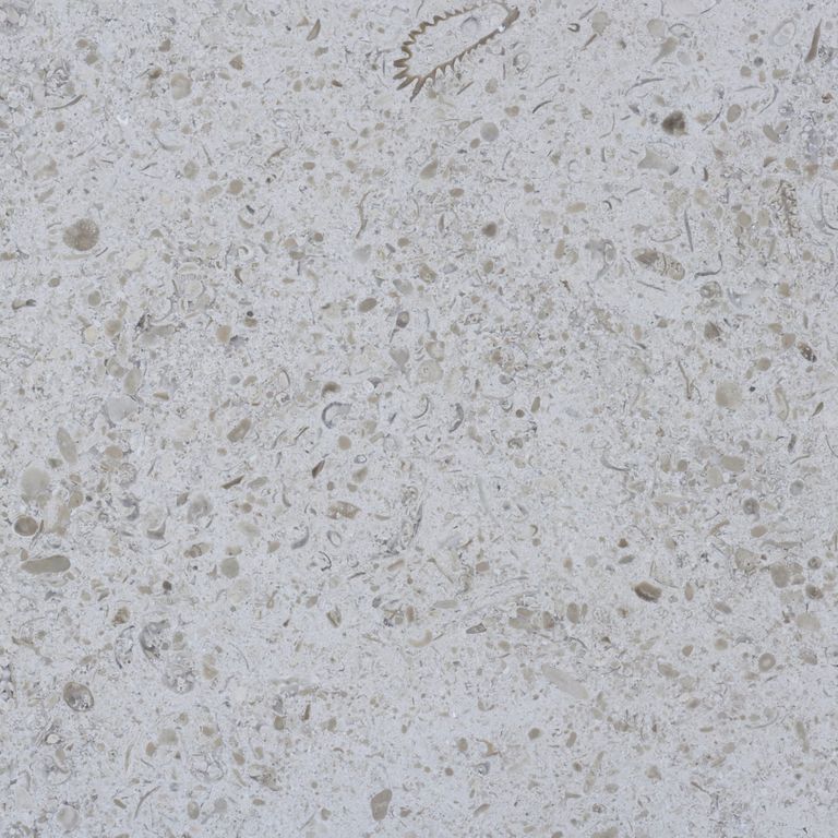 Swatch image for Limestone - Topa Beige. The surface finish shown is honed. The dominant color shown is gray; with beige, blue and tan secondaries. The color mix creates a cool feeling. Blotched and coarse speckled color patterns. Contains mineral inclusions.