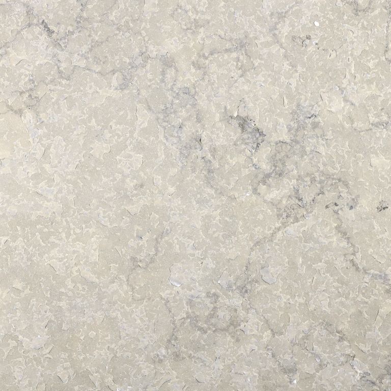 Close-up image for Sky Prima Limestone. The surface finish shown is flamed. Dominant colors shown are beige and cream; with gray, white and tan secondaries. Exhibits 