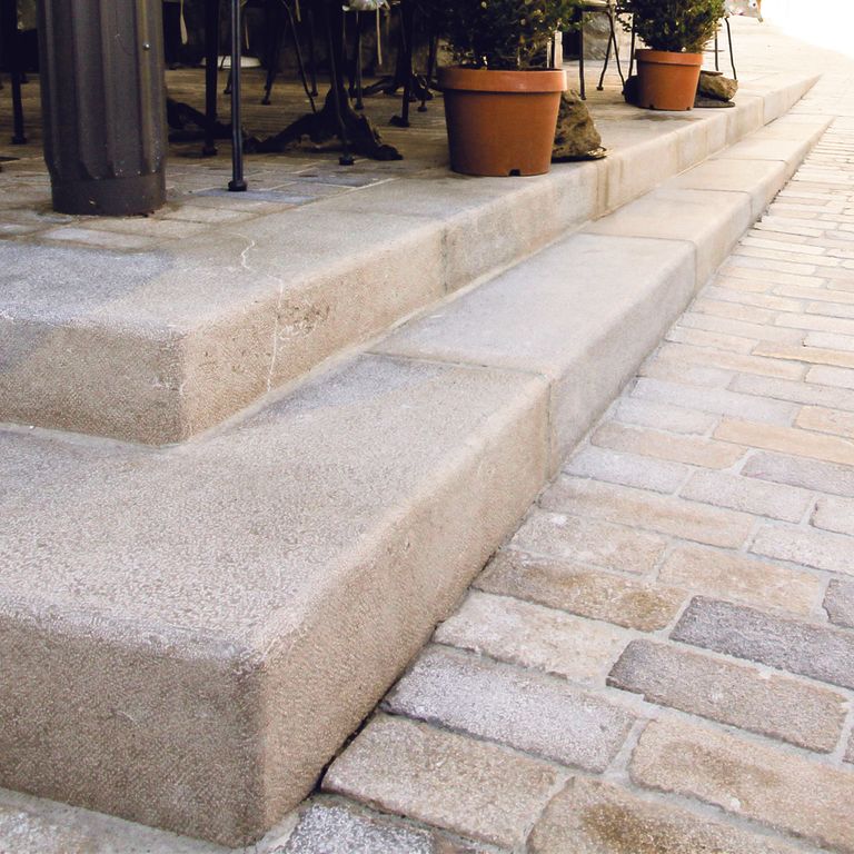 Application image for Limestone - Portuguese Amaza Estrema. The image shows this material being used for path pavers, patio pavers and monolithic steps.