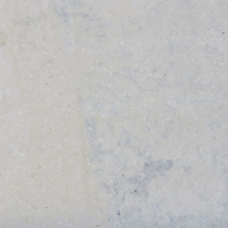 Color/Finish variation image for Valamaza Limestone. The surface finishes shown are brushed and flamed. Dominant colors shown are beige, gray and white; with pink and purple secondaries. Exhibits 