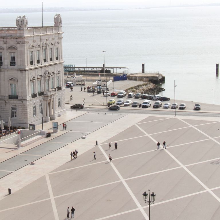 Feature image for Limestone - Portuguese Liacado. The image shows this material being used for patio pavers and public area. The dominant color shown is gray; with beige, pink, purple, white, tan and cream secondaries. The color mix creates a warm feeling. Solid color pattern.