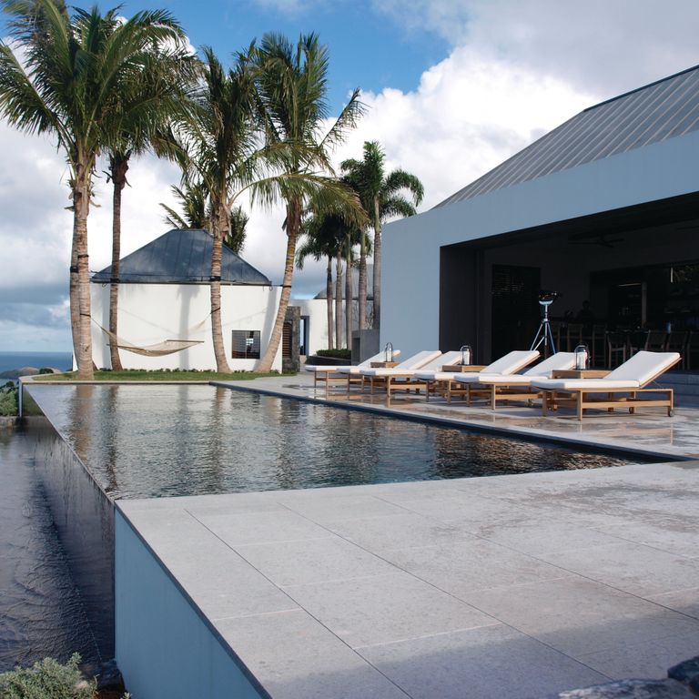 Feature image for Limestone - Classimo Sky. The image shows this material being used for pool coping and pool deck pavers. Dominant colors shown are gray and white. The color mix creates a cool feeling. Regular and fine speckled color patterns.