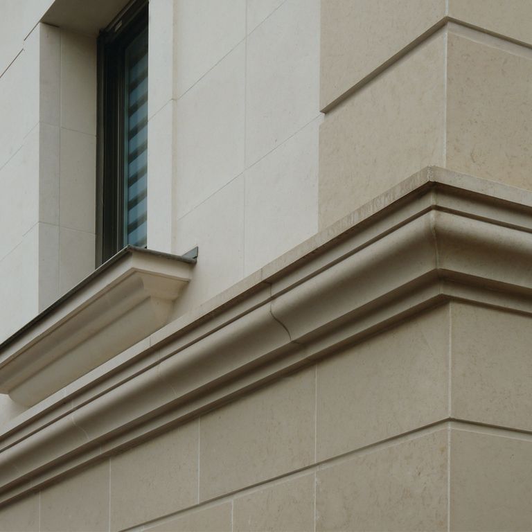 Application image for Limestone - Portuguese Sarafa Gold. The image shows this material being used for architectural elements, full bed veneer and window well.