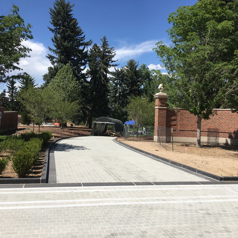 The image shows this material being used in a driveway pavers application.