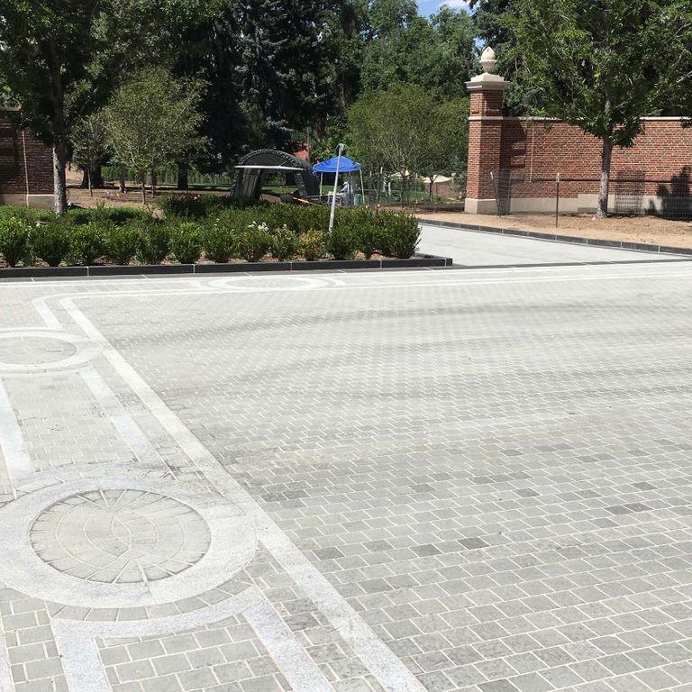 The image shows this material being used in a patio pavers application.