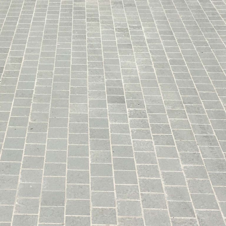 The image shows this material being used for driveway pavers and patio pavers.