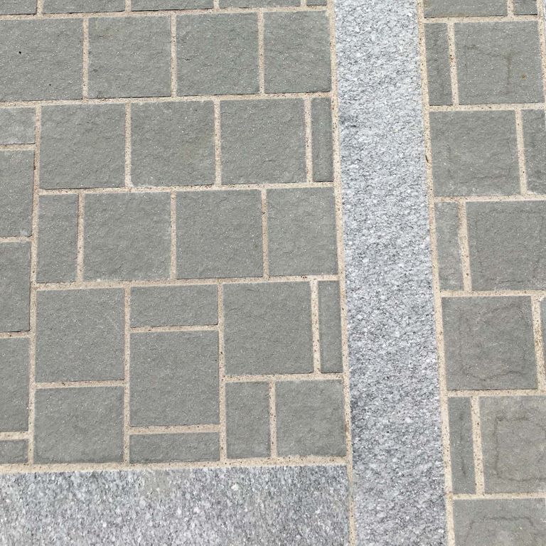 The image shows this material being used for driveway pavers, path pavers and patio pavers.