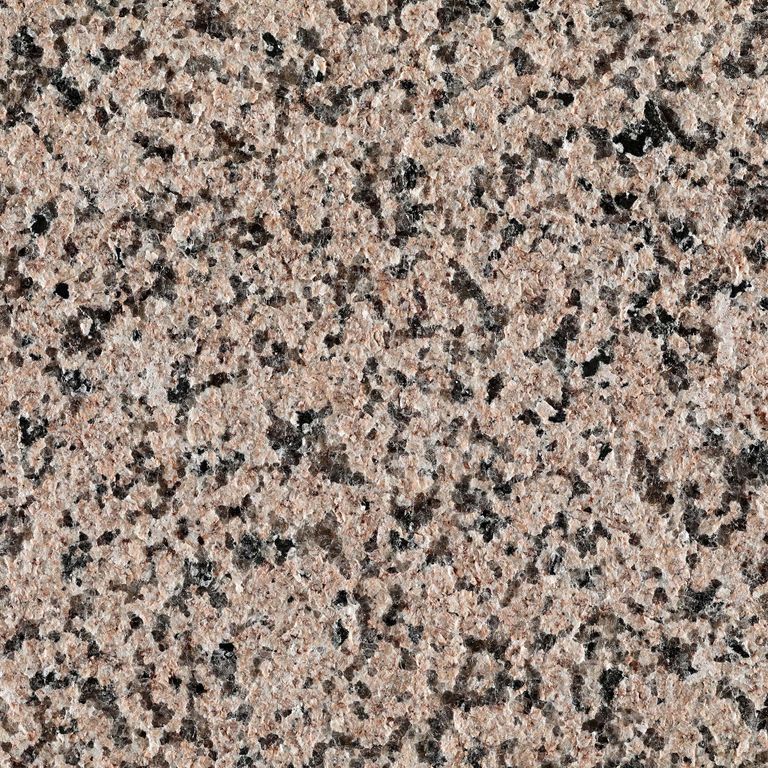 Best close-up image for Granite - Red Star. The surface finish shown is flamed. The dominant color shown is pink; with black, orange/rust, pink, purple, white and cream secondaries. The color mix creates a warm feeling. Regular, speckled and blotched color patterns. Contains some mica and mineral inclusions.
