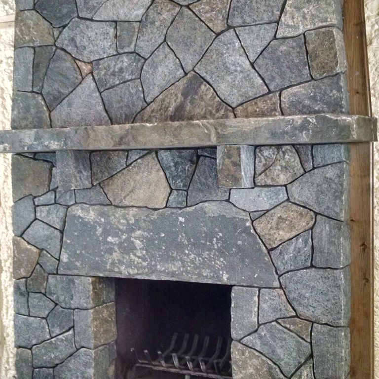 The image shows this material being used for fireplace surround and thin veneer.