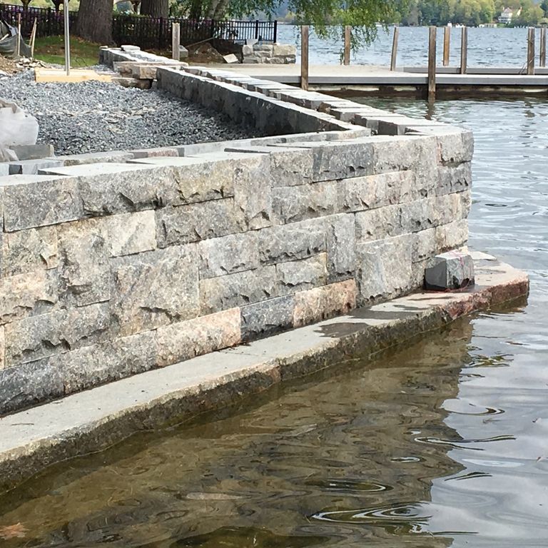 The image shows this material being used in a landscape wallstone application.