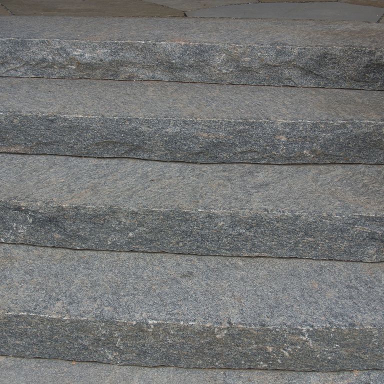 Application image for Hawthorne Granite. The image shows this material being used in a monolithic steps application. This is a building and landscape stone for indoor and outdoor commercial and residential applications. Suitable for general use, freeze-thaw conditions, low heat absorption surfaces, high traffic areas, low slipperiness surfaces and high heel compatibilty situations. Relatively higher in price.