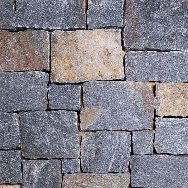 Close-up image for Saranac Granite. Dominant colors shown are blue and gray; with beige, brown, orange/rust, purple, white and tan secondaries. Exhibits 