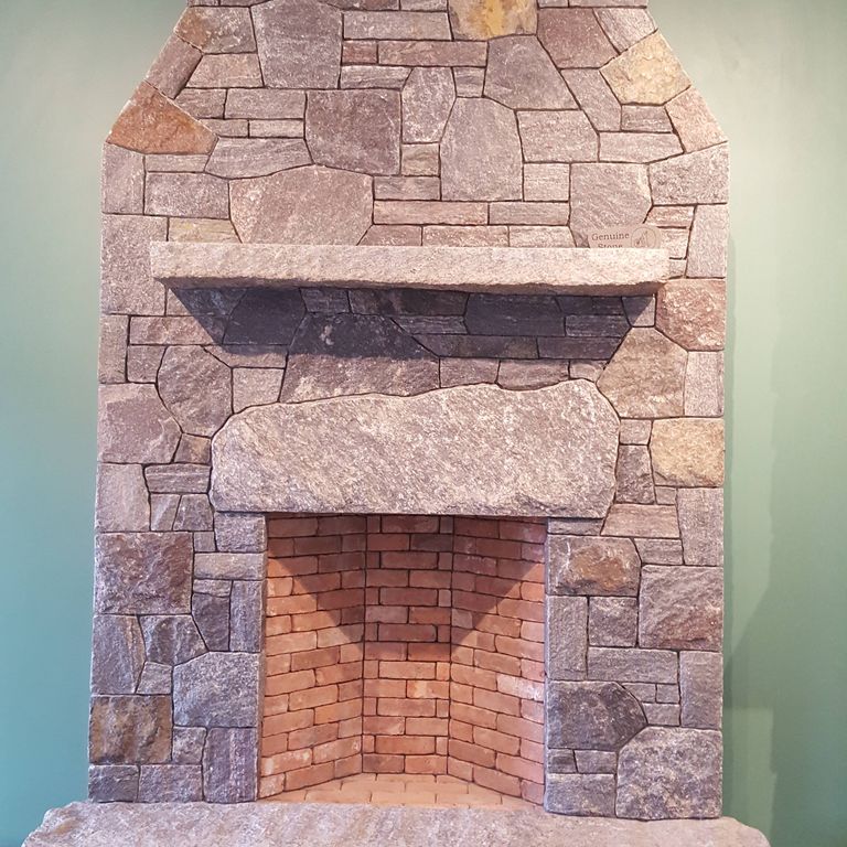 Application image for Saranac Granite. The image shows this material being used for fireplace hearth, fireplace mantel and fireplace surround. This is a building and landscape stone for indoor and outdoor commercial and residential applications. Suitable for general use, freeze-thaw conditions, low heat absorption surfaces, high traffic areas, low slipperiness surfaces and high heel compatibilty situations. Relatively higher in price.