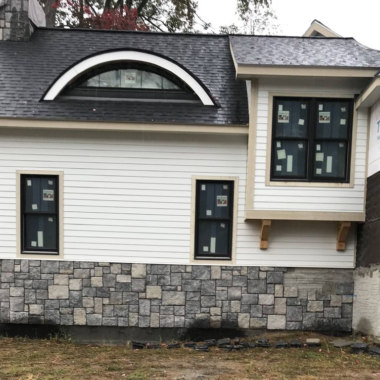 Feature image for Northern Gray Limestone. The image shows this material being used for full bed veneer and thin veneer. The dominant color shown is gray; with beige, black, blue, brown, green, orange/rust, purple, white, tan and cream secondaries. The color mix creates a warm feeling. Random, speckled and cloudy color patterns.