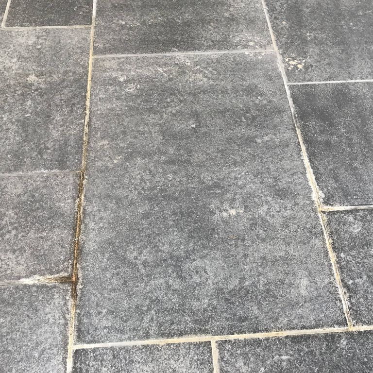 The image shows this material being used in a patio pavers application.