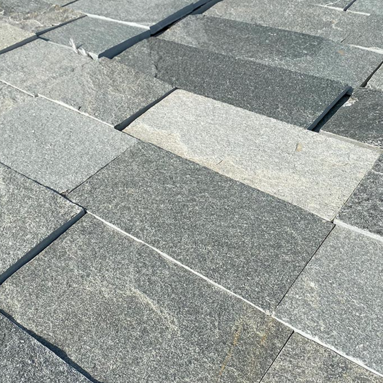 Best close-up image for Greek Quartzite Slate - Grey. The surface finish shown is natural cleft. The dominant color shown is gray; with beige, blue, green, pink, purple and white secondaries. Exhibits 