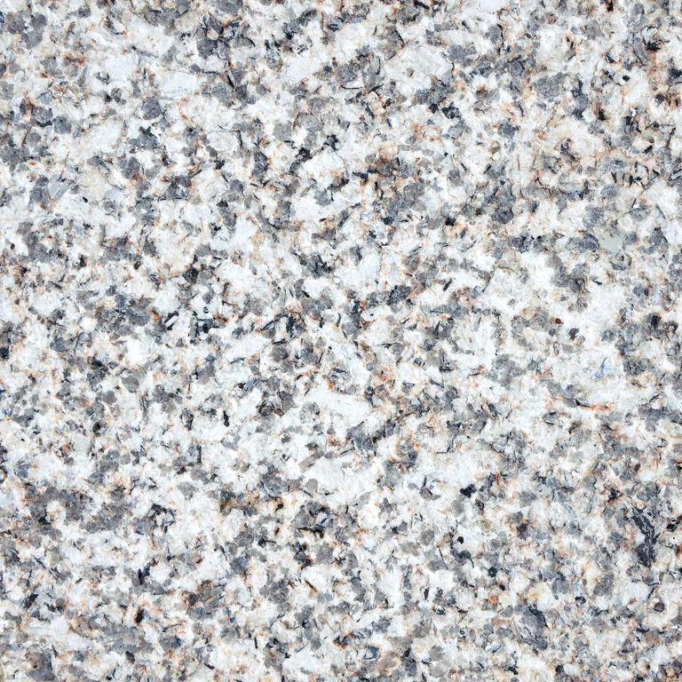 Color/Finish variation image for Yellow Corn Granite. The surface finish shown is flamed. The dominant color shown is tan. The color mix creates a warm feeling. Coarse speckled color pattern.