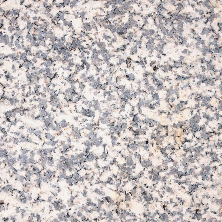 Color/Finish variation image for Yellow Corn Granite. The surface finish shown is honed. Dominant colors shown are gray and tan. The color mix creates a cool feeling. Coarse speckled color pattern.