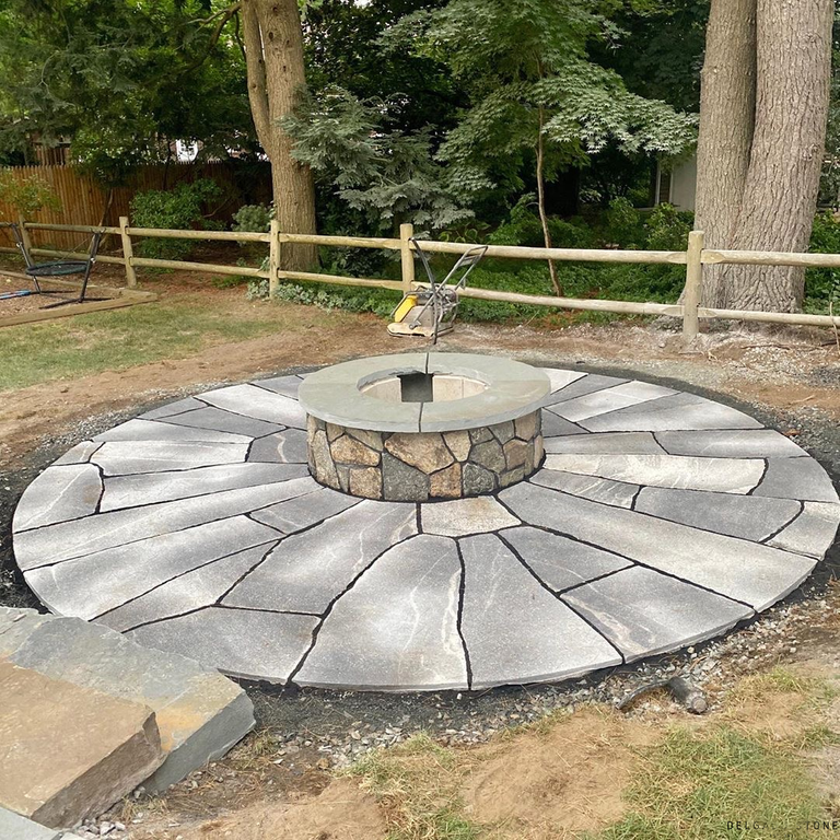 Feature image for Fitzwilliam Granite. The image shows this material being used in a patio pavers application. The dominant color shown is gray; with beige, white and cream secondaries. Exhibits 