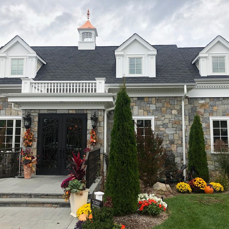 Feature image for Granite - Connecticut Blend- Thin Veneer. The image shows this material being used in a thin veneer application. Dominant colors shown are gray and tan; with brown, green and orange/rust secondaries. The color mix creates a warm feeling. Speckled and random color patterns.