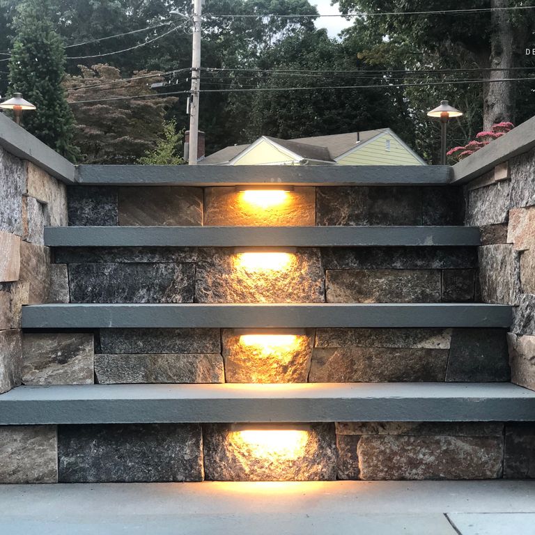 Application image for Granite - Connecticut Blend Thin Veneer. The image shows this material being used for landscape wallstone and treads.