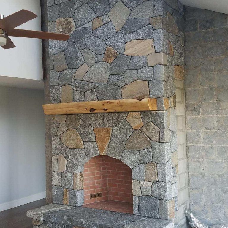 Application image for Granite - Connecticut Blend- Thin Veneer. The image shows this material being used for fireplace surround, thin veneer and interior cladding.