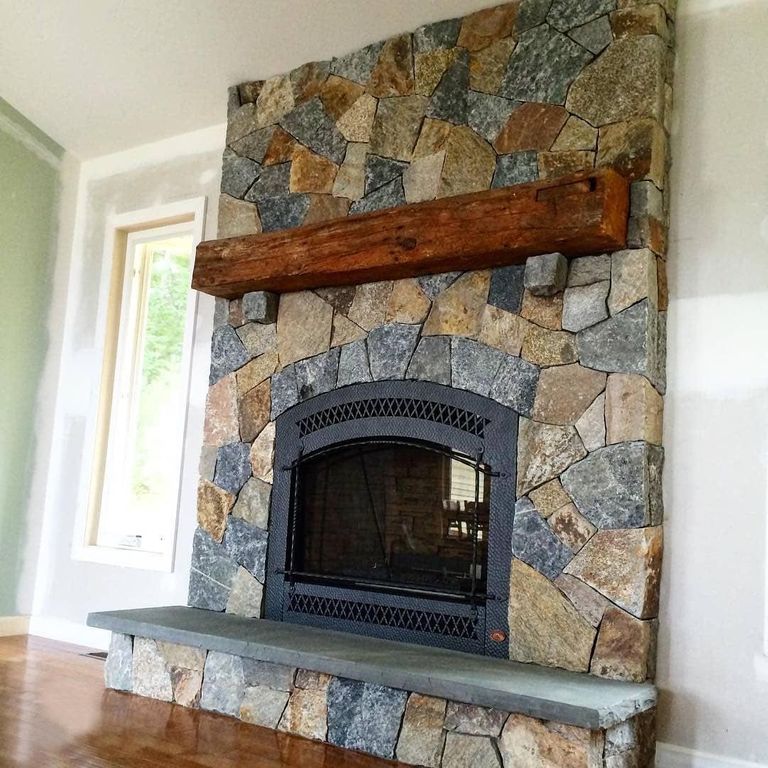 Application image for Granite - Connecticut Blend- Thin Veneer. The image shows this material being used for fireplace surround, thin veneer and interior cladding.