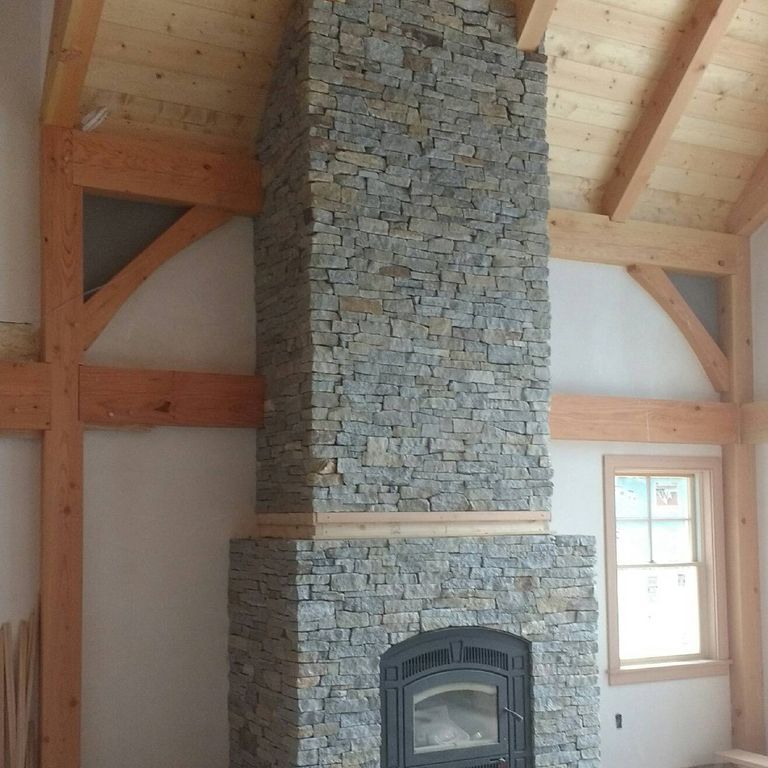 Application image for Granite - Connecticut Blend- Thin Veneer. The image shows this material being used for fireplace hearth, fireplace surround, thin veneer and interior cladding.