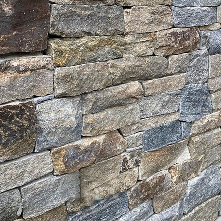 Best close-up image for Montauk Blend Granite. The image shows this material being used in a full bed veneer application. The surface finish shown is . Dominant colors shown are brown, gray and tan; with beige, gray, orange/rust and purple secondaries. The color mix creates a warm feeling. Regular, linear and blotched color patterns.